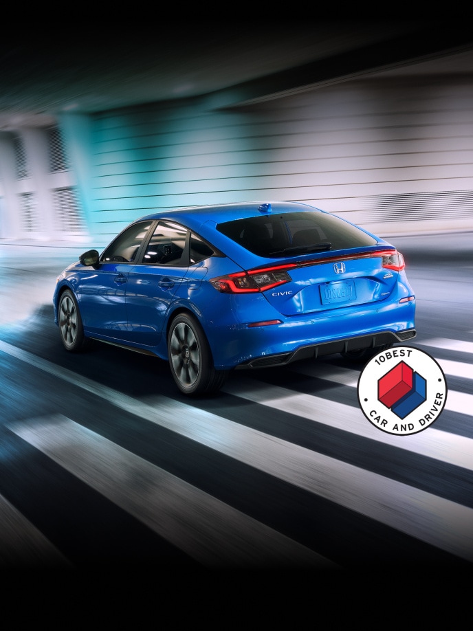 2025 Honda Civic Hatchback Sport Touring Hybrid in Boost Blue Pearl rear view with overlapping Car and Driver 10Best logo (Compact Hatchback).