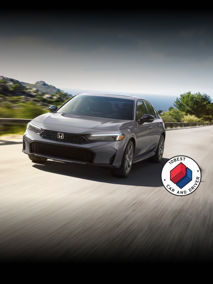 2026 Honda Civic Sedan Sport Touring Hybrid in Urban Gray Pearl front view with overlapping Car and Driver 10Best logo (Compact Sedan).