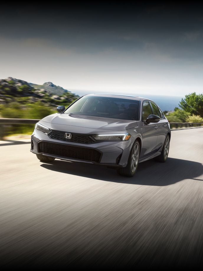 2026 Honda Civic Sedan Sport Touring Hybrid in Urban Gray Pearl in cornering  mountain road outdoor environment