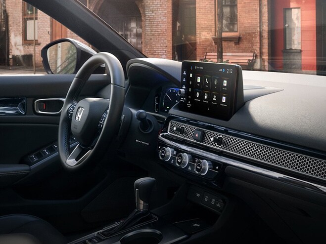 2026 Honda Civic Sedan Sport Touring Hybrid dashboard and center console view parked on a city street (Compact Sedan)